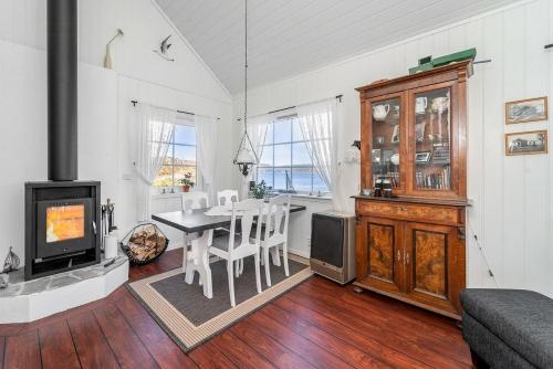 a kitchen and dining room with a table and a stove at Explore Håøya Nature Reserve in Helgeroa