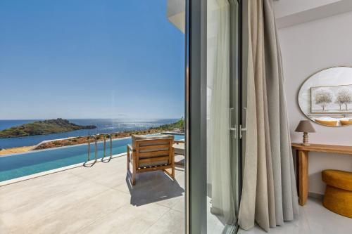 a room with a view of the ocean at Armoi Villas in Agios Nikolaos