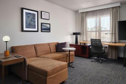 a living room with a couch and a desk at Residence Inn by Marriott Las Vegas Henderson/Green Valley in Las Vegas