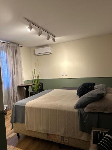 a bedroom with a large bed in a room at Grey House in Foz do Iguaçu