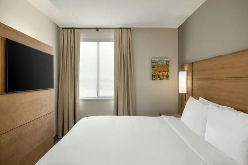 a hotel room with a large bed and a window at Residence Inn by Marriott San Luis Obispo in San Luis Obispo
