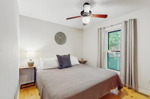 Un dormitorio con una cama y un ventilador de techo. en Hatcher's Haven, en Sevierville