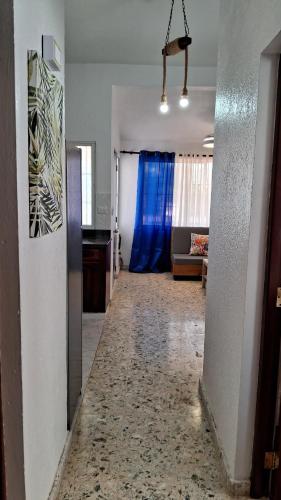 a long hallway with a blue curtain in a living room at CortLang Vacation Rentals, Costambar in San Felipe de Puerto Plata