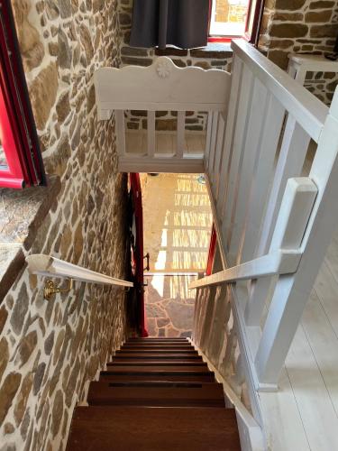 a stairway with a white chair sitting on top at Rodakas Rooms-Glikeria in LivadhokhÃ³rion