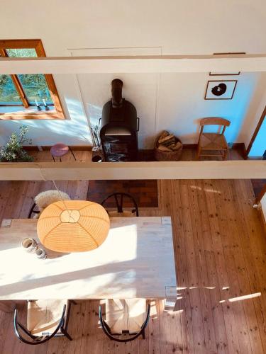 a man sitting at a table in a tiny house at Historic House South Of Copenhagen in Borup