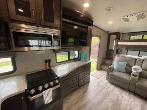 a kitchen and living room of an rv at The Reflection-Walk to Oaklawn & Bathhouses in Downtown Hot Springs in Hot Springs