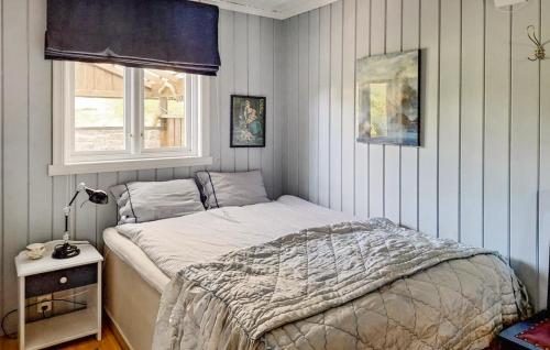 a bedroom with a bed and a window at Cozy Home In Florø With Wifi in Florø