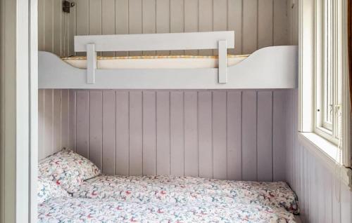 a small room with a bed and a window at Cozy Home In Florø With Wifi in Florø