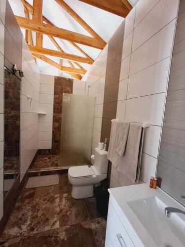 a bathroom with a toilet and a sink at Duineveld Self Catering Cottage in Kalkrand