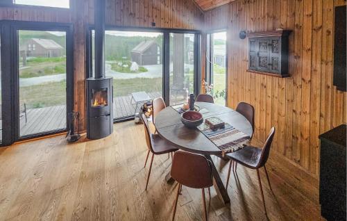 a dining room with a table and a wood stove at Stunning Home In Nesbyen With Wifi in Nesbyen
