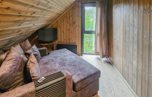 a bedroom with a large bed and a television at Stunning Home In Nesbyen With Wifi in Nesbyen