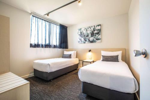 a hotel room with two beds and a window at Nightcap at Westside Hotel in Laverton