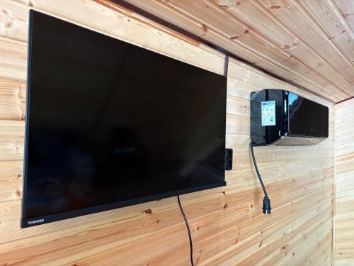 a large flat screen tv hanging on a wall at Wooden House Martvili in Martvili