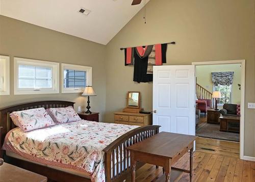 a bedroom with a bed and a table in it at Pet-Friendly Getaway With Spectacular Mountain View in Saluda