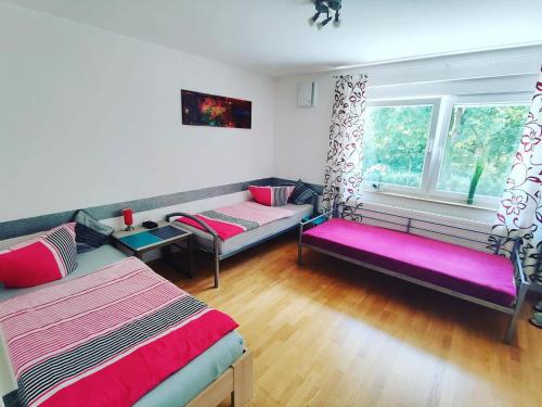 a living room with two beds and a window at Ferienhaus Bailey in Laupheim