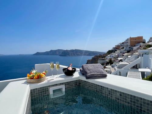 a swimming pool on the side of a building at Èther suites Oia in Santorini