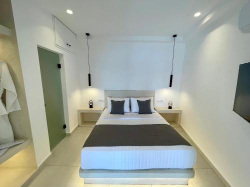 a bedroom with a large bed in a room at Èther suites Oia in Santorini