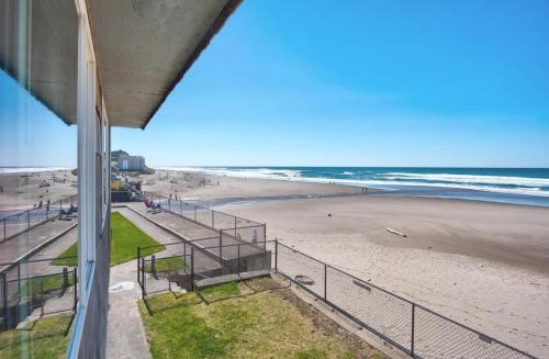a view of the beach from a balcony at Sea Gypsy Rentals - Oceanfront Suite in Lincoln City