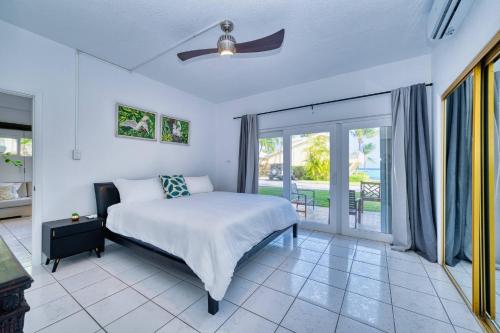 a bedroom with a bed and a balcony at Quiet Beach Escape in George Town