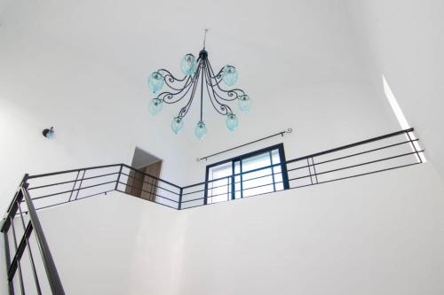a chandelier hanging from the ceiling in a room at Deux Villas Privees Luxe avec Maison dAmis en Option a Hammamet in Yasmine