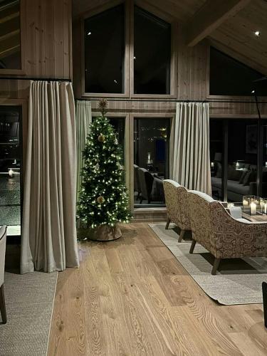 a christmas tree in the middle of a living room at Premium Cabin By Kvitfjell Ski Slopes in Ringebu