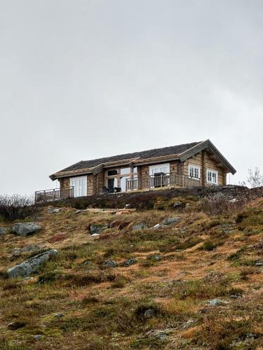 a house sitting on top of a hill at Spectacular Cabin With View In Jotunheimen in Eidsbugarden