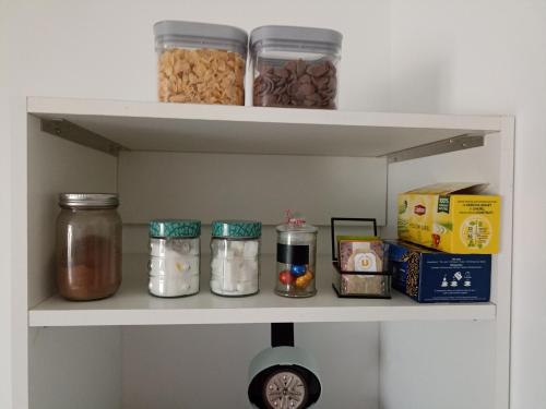 a shelf with nuts and other food items on it at Chambre privée in Montaigu-Vendée