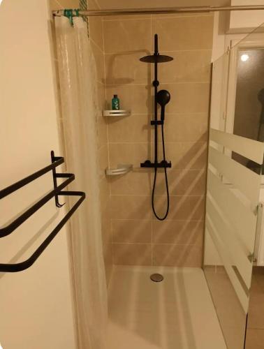 a bathroom with a shower with a shower at Chambre privée in Montaigu-Vendée