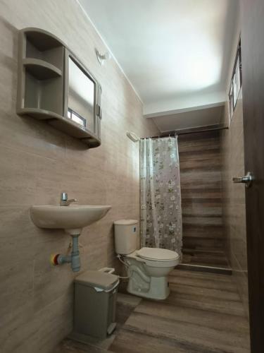 a bathroom with a toilet and a sink at Chazze House in Santa Marta