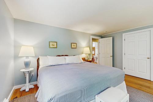a bedroom with a large bed with blue walls at The Village House in Manchester