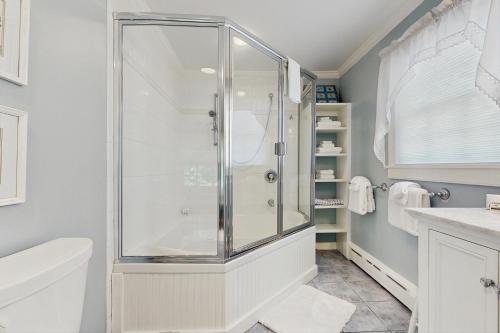 a bathroom with a shower and a toilet at The Village House in Manchester