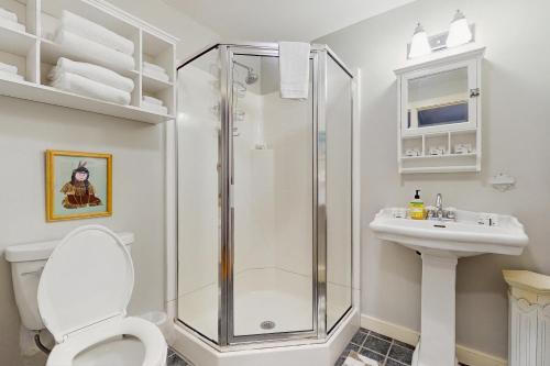 a bathroom with a shower and a toilet and a sink at The Village House in Manchester