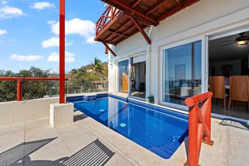 a swimming pool in the backyard of a house at Villa Alhelí | Ocean View 3BR w/ Private Pool, Steps to Beach – Sayulita in Sayulita