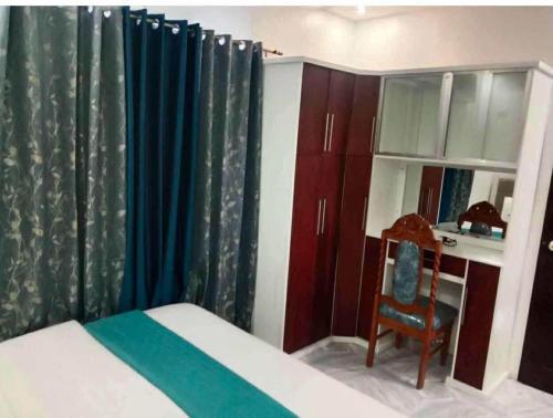 a bedroom with a bed and a desk and a chair at Tilano Whitestone Resort in Maria