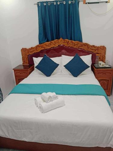 a bedroom with a bed with towels on it at Tilano Whitestone Resort in Maria