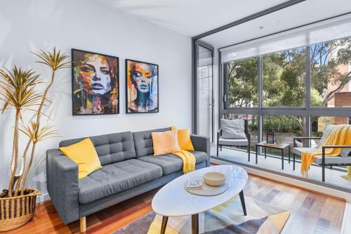 a living room with a couch and a table at The South Yarra Jewel in Melbourne