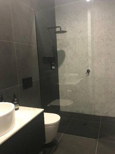 a bathroom with a shower with a toilet and a sink at Konayuki Penthouse 9 in Falls Creek
