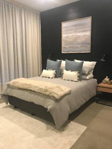 a bedroom with a large bed with white pillows at Konayuki Penthouse 9 in Falls Creek