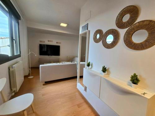 a living room with a bed and mirrors on the wall at Explore Tarazona from This Central & Peaceful Flat in Tarazona de Aragón