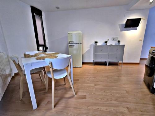a kitchen with a white table and a white refrigerator at Explore Tarazona from This Central & Peaceful Flat in Tarazona de Aragón