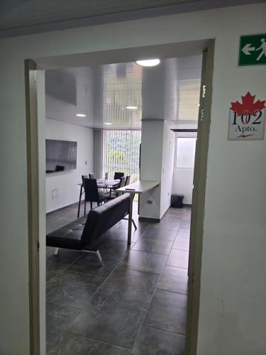 a living room with a table and a dining room at Vancouver 102 in Villamaría