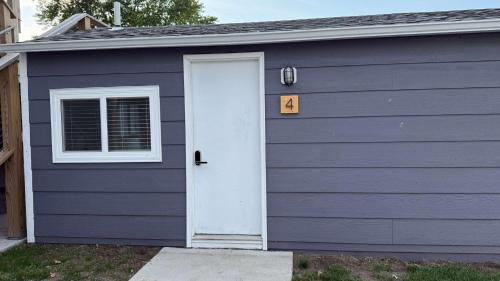 a garage with a white door and a number at Seasonal Cabin, sleeps 6 in Lake City