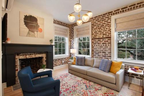 a living room with a couch and a fireplace at Luxury King Suite Full Kitchen 3rd Floor in Savannah