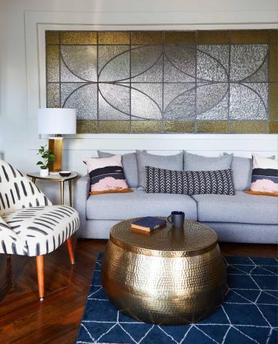 a living room with a couch and a coffee table at King Penthouse Suite Clawfoot Tub 4th Floor in Savannah
