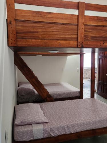 a bedroom with two bunk beds in a room at House on the Beach in Manzanillo