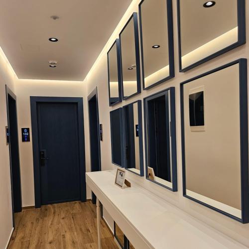 a hallway with a row of mirrors on the wall at Boutique Vila Ahmeti in Sarandë