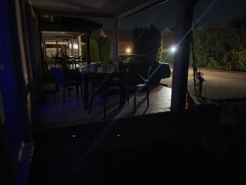 a table and chairs on a porch at night at Vizbeg Inn in Skopje