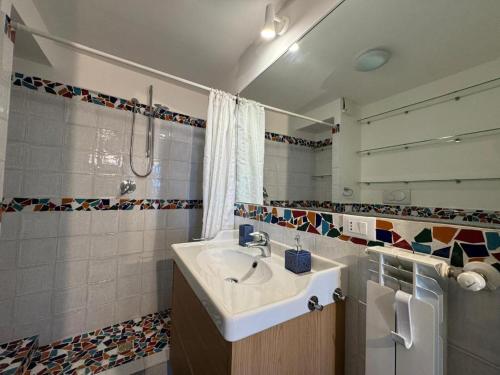 a bathroom with a sink and a mirror at Appartamento Selene in Monopoli