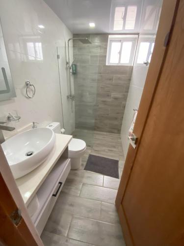 a bathroom with a sink and a toilet and a shower at Cozy Tropical Getaway in Los Altos de Jalisco