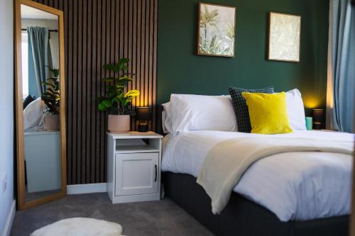 a bedroom with a bed with a yellow pillow at Home from home in Gilesgate